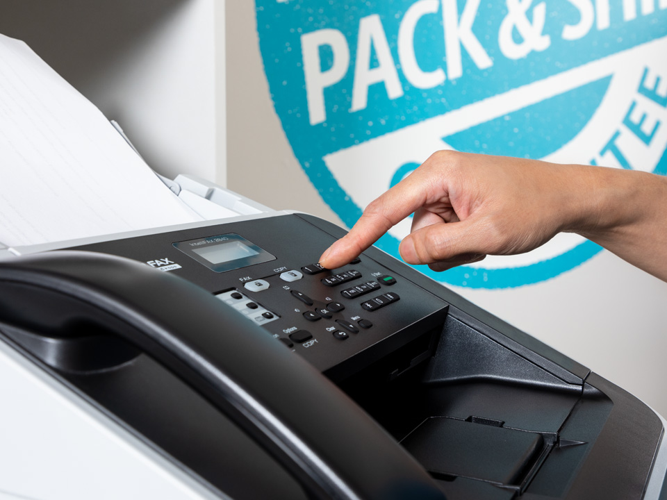 Customer using a fax machine at the UPS Store