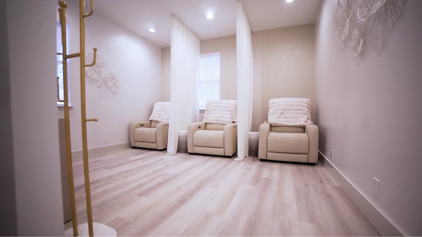 White ergonomic medical spa treatment chair in a luxury Miramar Beach aesthetic clinic.