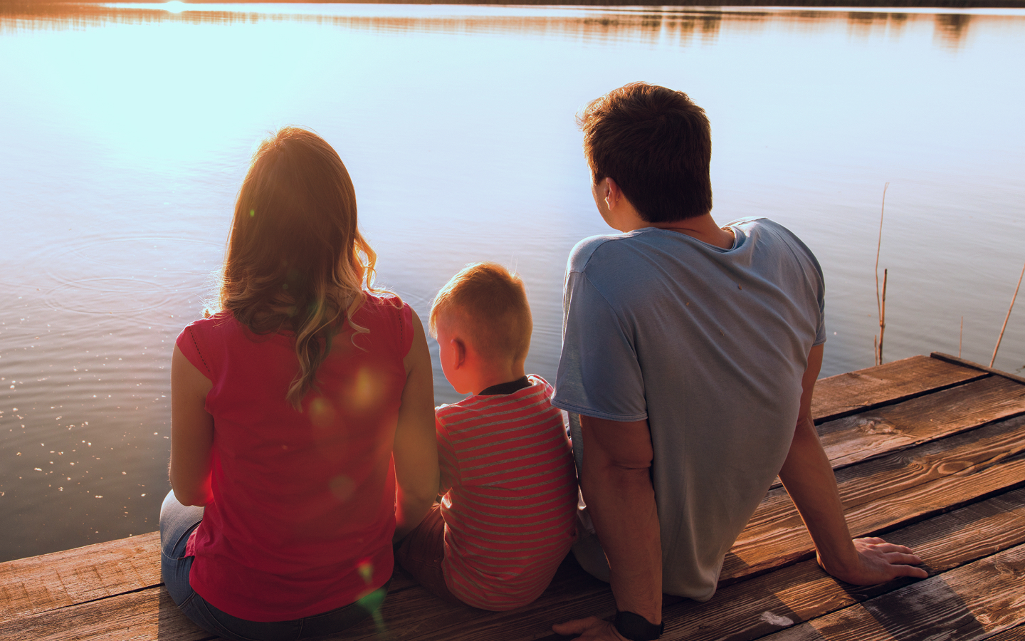 A family on a dock enjoying the view.