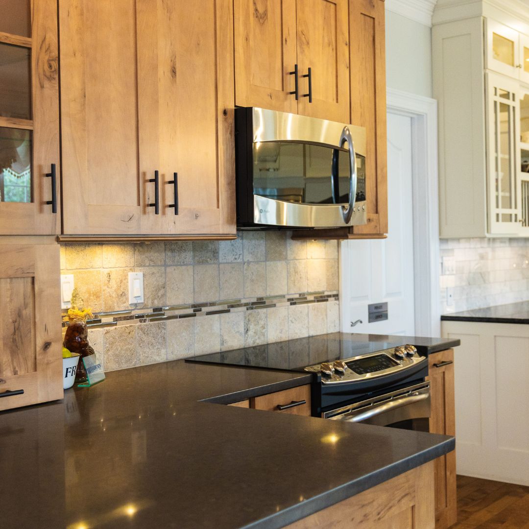 Rustic wood cabinetry paired with tile backsplash and dark countertops for a warm, natural kitchen aesthetic.
