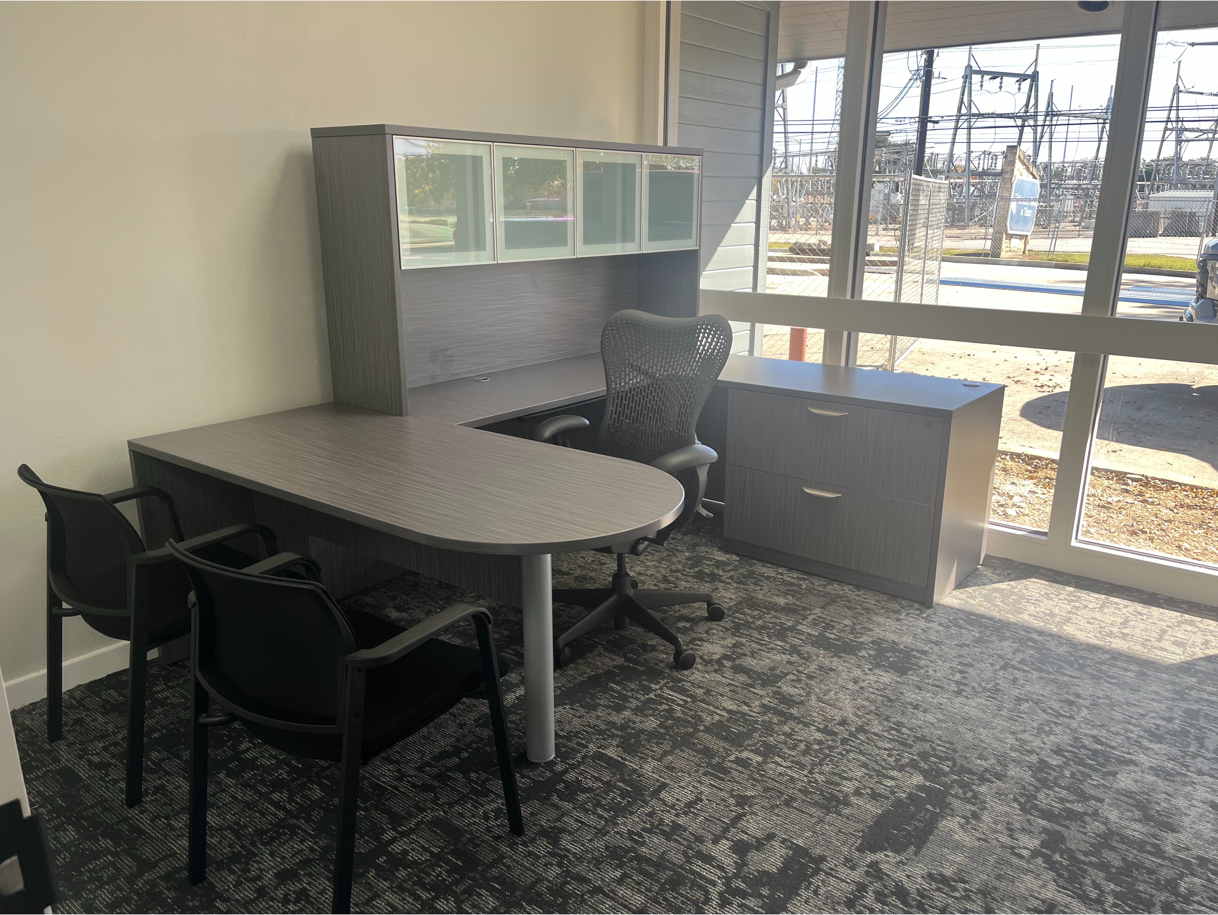 Height-Adjustable Standing Desk Setup:

Sit-stand electric desk integrated into a low-divider cubicle pod, paired with an ergonomic mesh office chair.