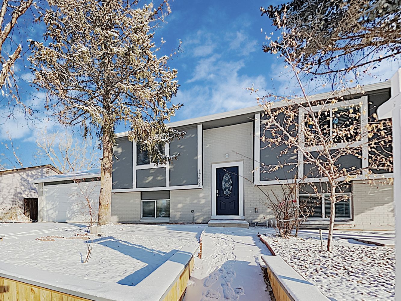 Modern front of home with nice walkway at Invitation Homes Denver.