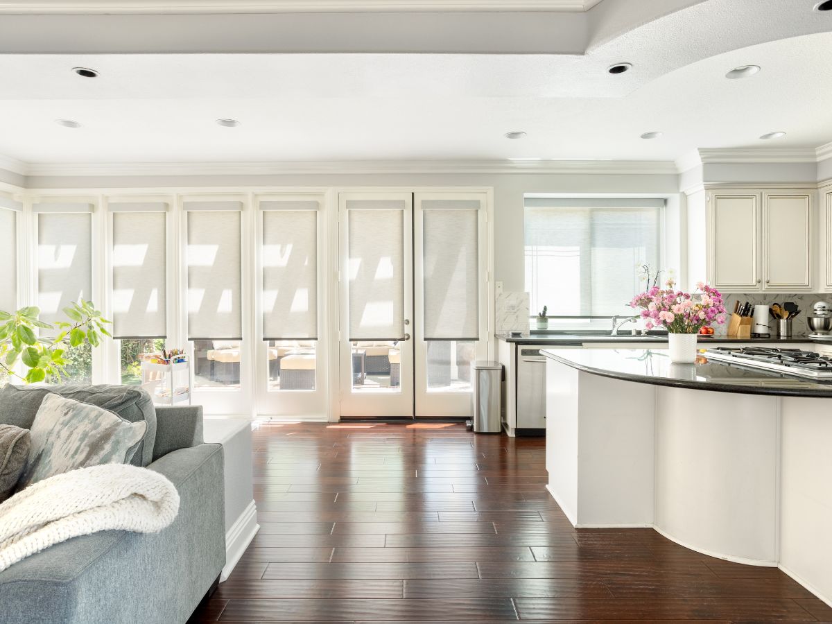 Roller shades installed in a bright, open kitchen space.