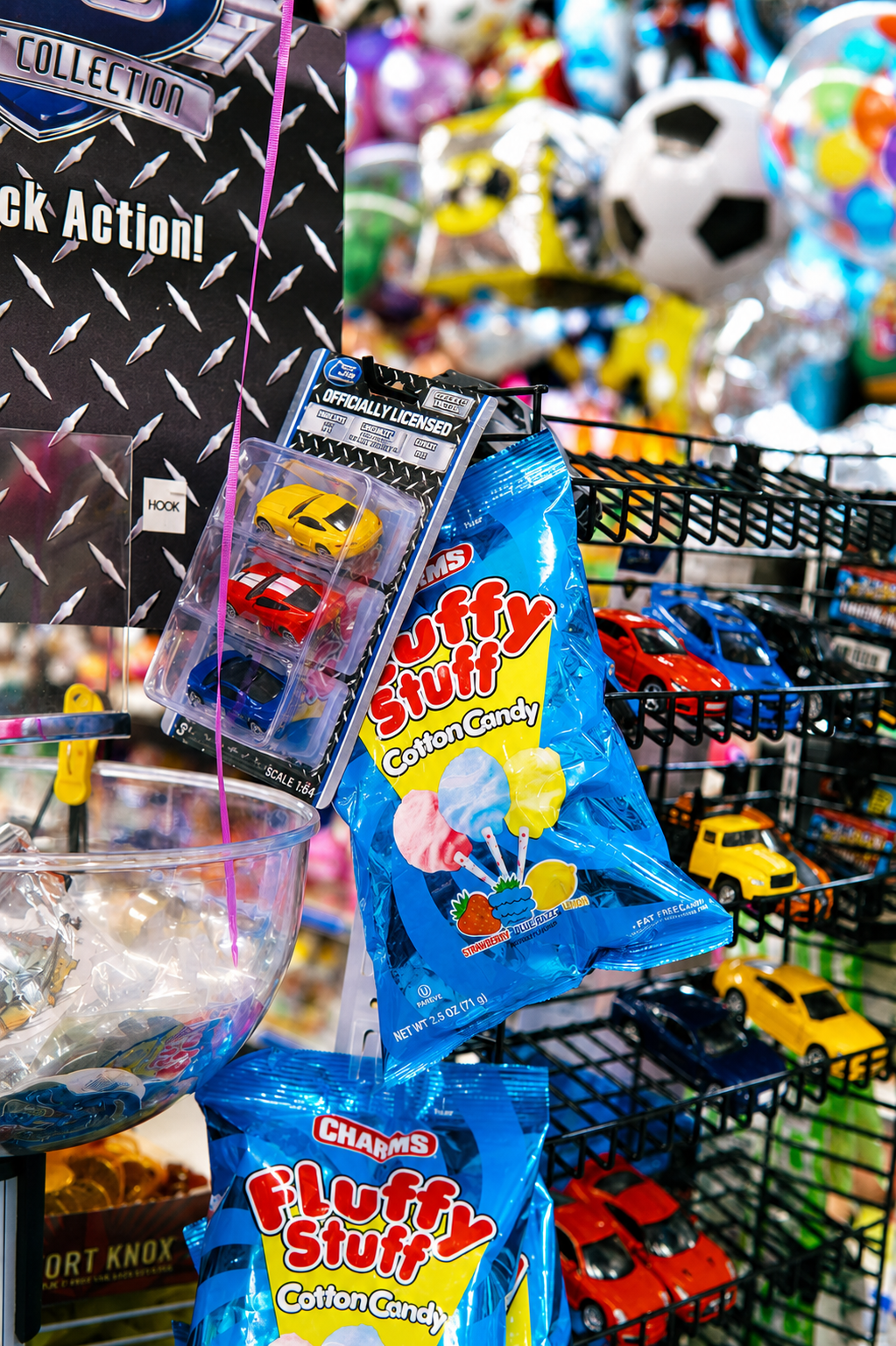 Fun retail display featuring collectible toy cars, cotton candy treats, and party essentials. A colorful selection of novelty items, snacks, and gifts perfect for kids, parties, and special occasions.