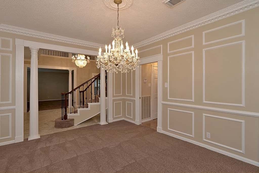 Stunning dining room with beautiful chandelier and intricate walls at Invitation Homes Houston.