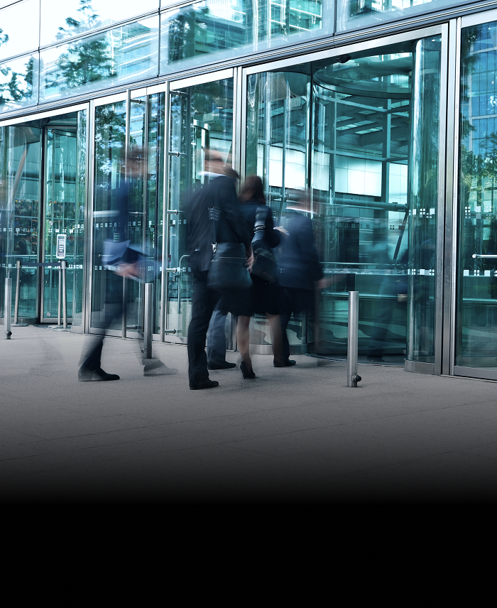 A group of professionals entering an office building.