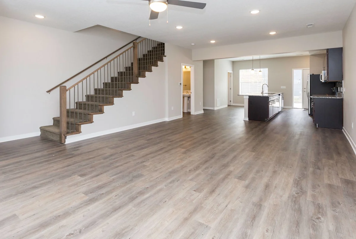 Living room with kitchen island and staircase