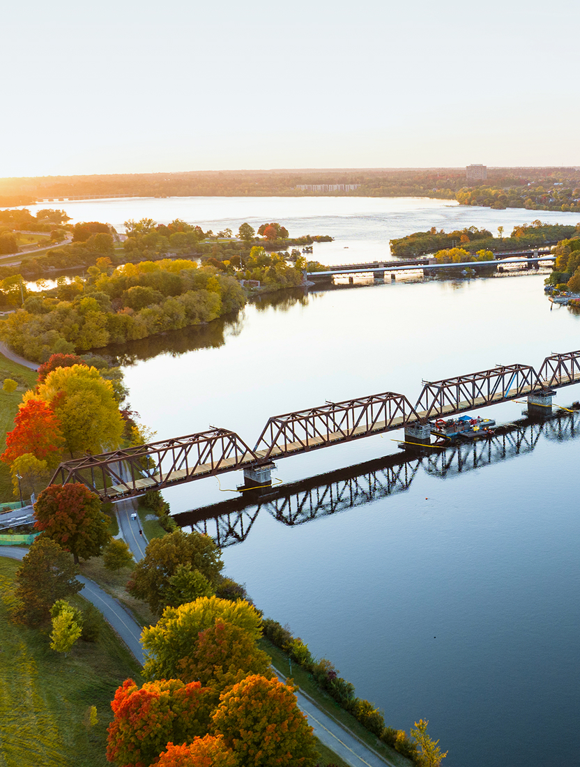 An aerial view of bridges spanning the Rideau Canal in Ottawa at sunrise.