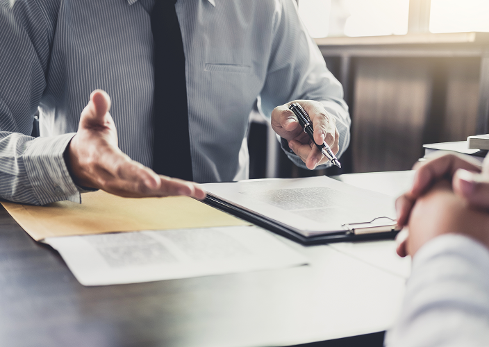 Close-up of an advisor's hands as he speaks to a client.