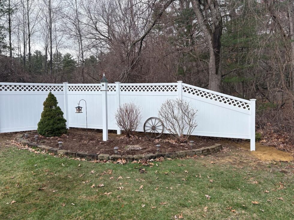 This project features durable 6-foot white vinyl privacy panels accented with a diagonal lattice top for added style and airflow.