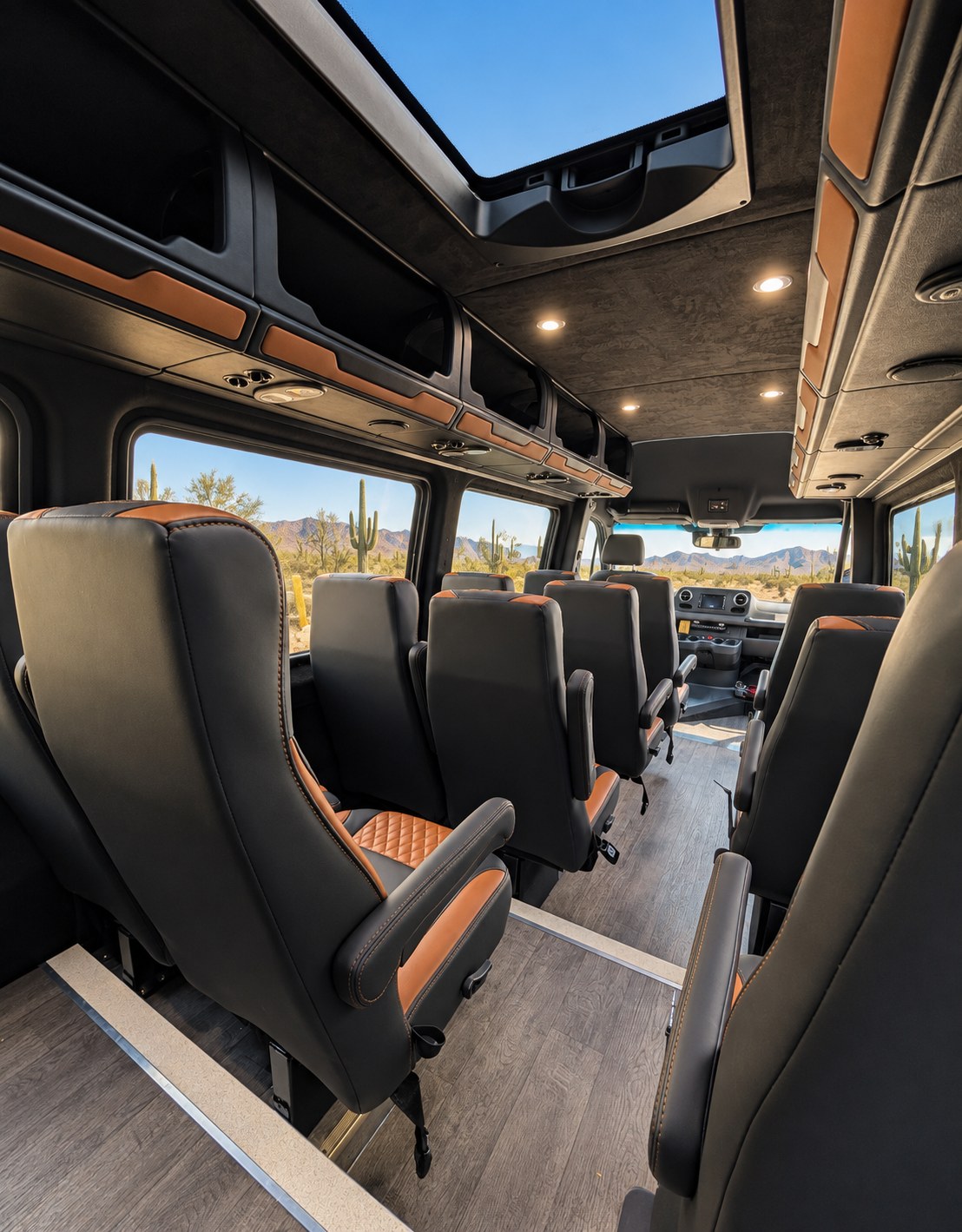 Passenger shuttle interior with overhead storage and forward-facing seating.