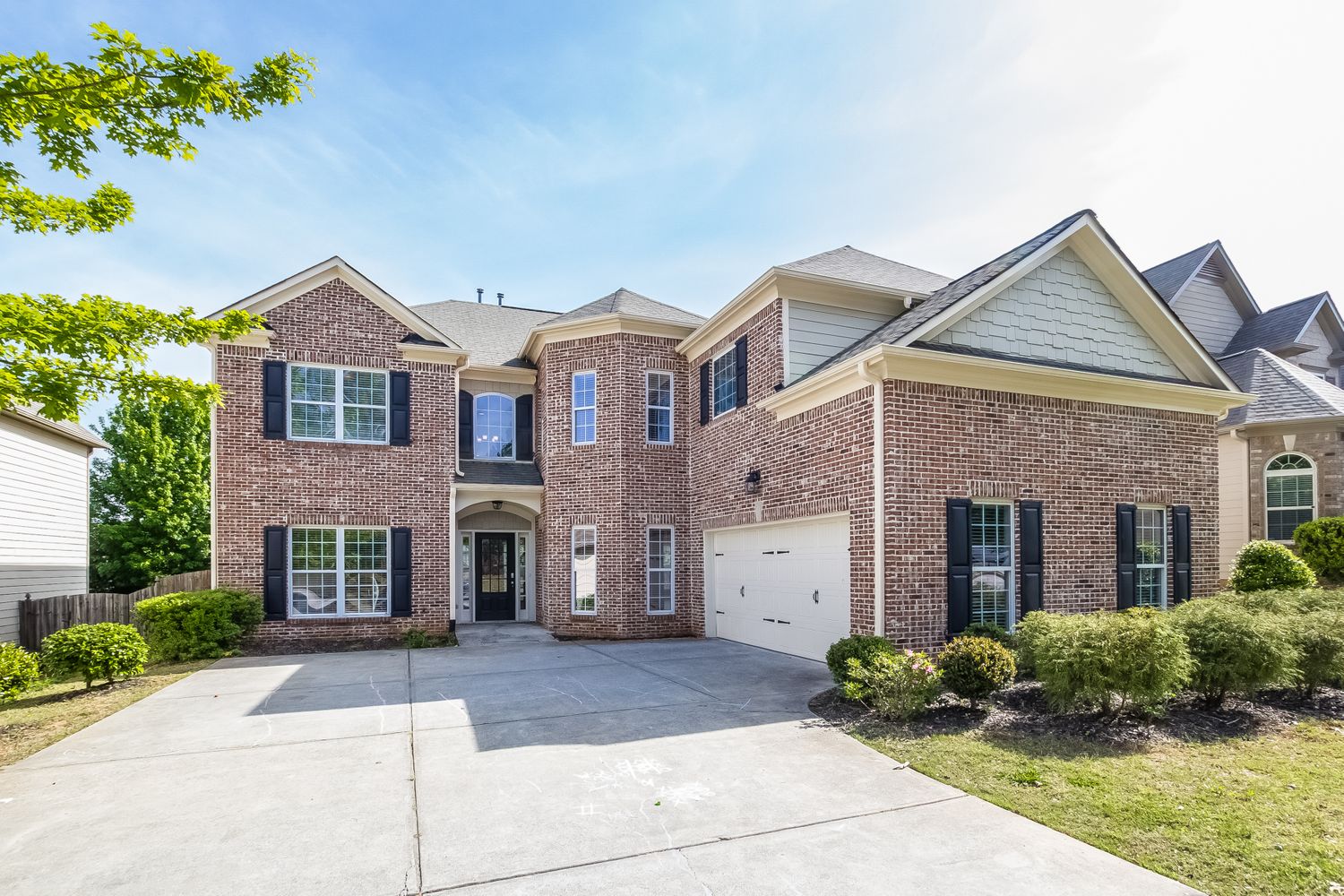 Gorgeous brick home with an extended driveway and two-car garage at Invitation Homes Atlanta.