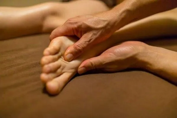 Professional deep tissue foot massage focusing on pressure points, muscle relaxation, improved circu 