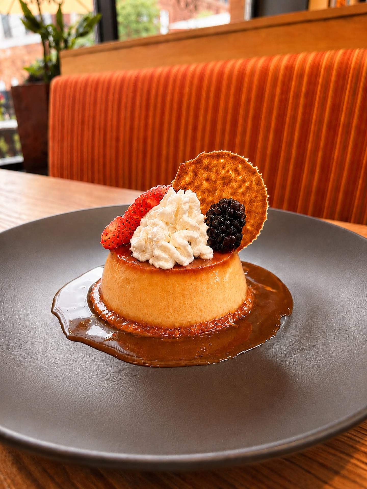 Rich, velvety salted caramel flan topped with fresh whipped cream, sweet strawberries, and a delicat 