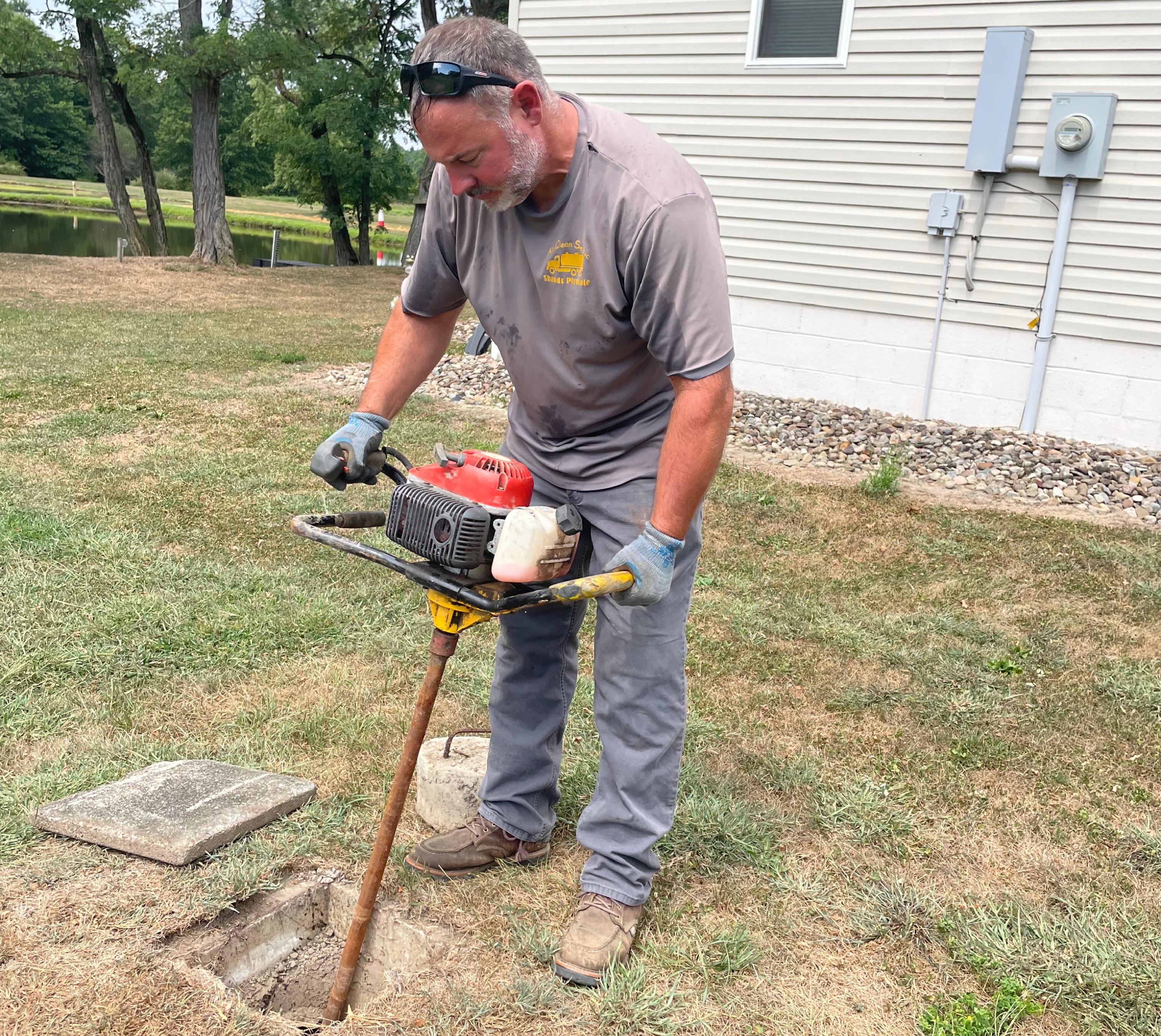 Shands Plymale, owner of All Clean Septic, agitating septic sludge with his trusty Crustbuster before performing septic pumping at a Portage County, OH home.