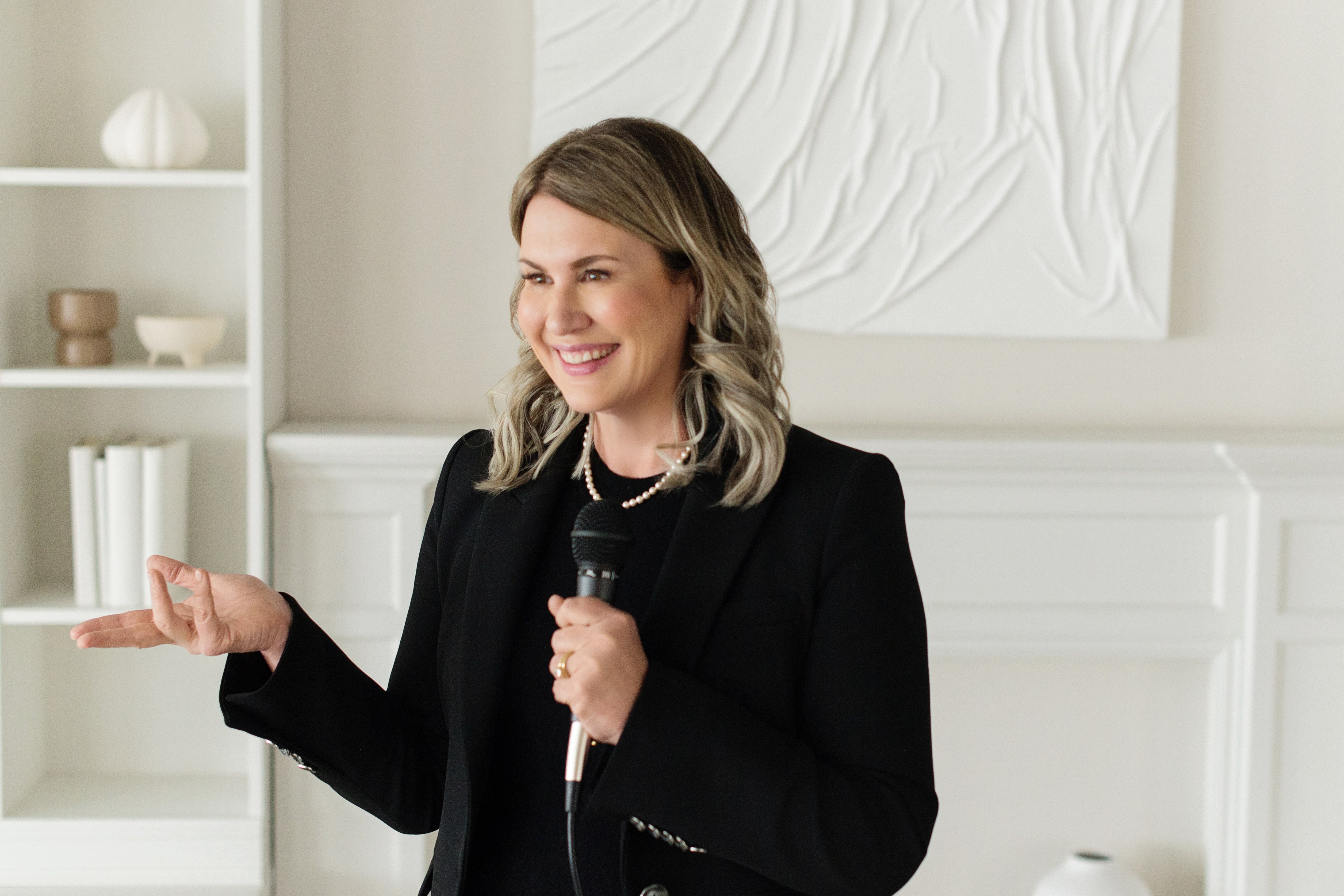 Shannon speaking with a micrphone to an audience