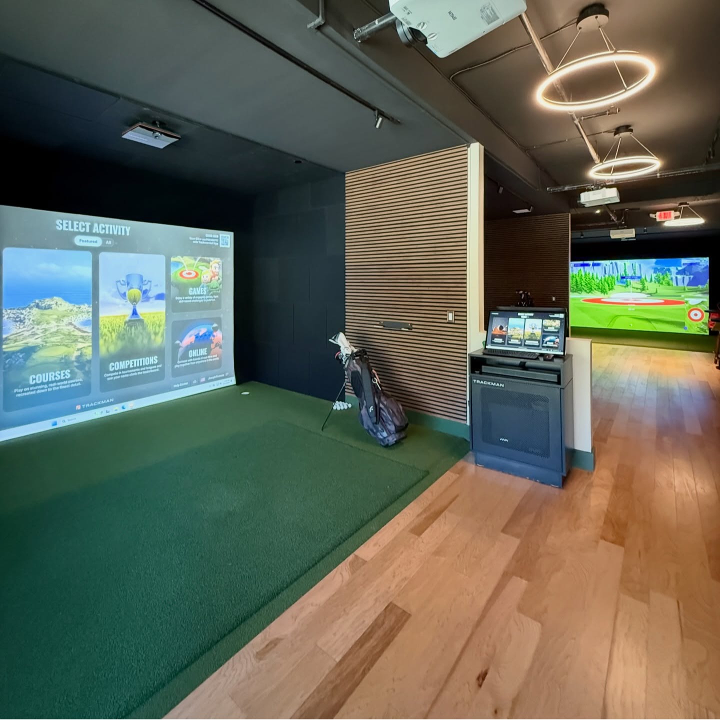 One of The Approach Shot's modern TrackMan simulator bays, designed for realistic indoor golf, practice sessions, and year-round play in a comfortable club-style setting.