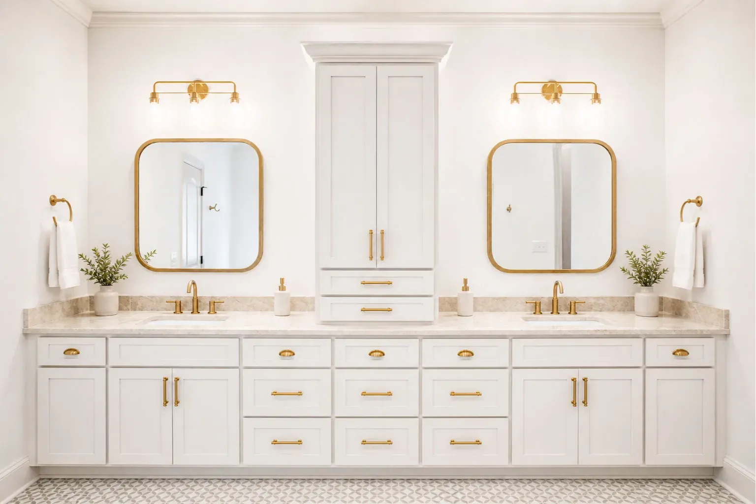 Elegant Symmetrical Double Vanity: Highlights a floor-to-ceiling linen tower, matching curved gold-framed mirrors, and patterned floor tile.