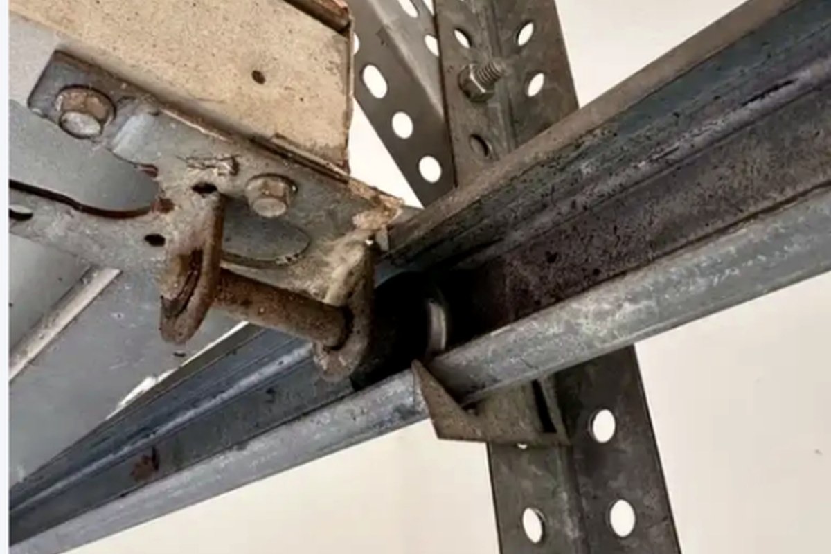 Close-up of residential garage door roller and track hardware inspected by Garage Fixer. 