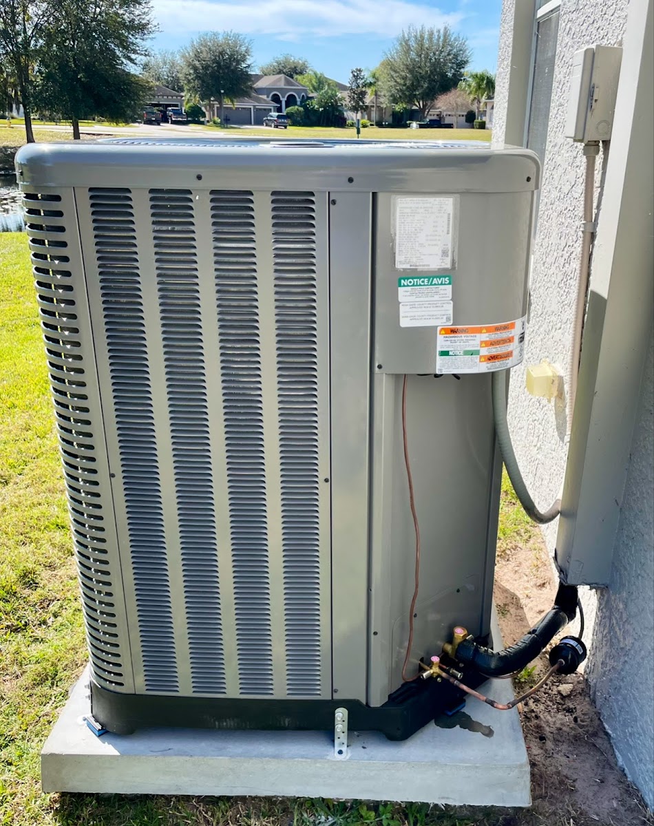 Outdoor air conditioning condenser installed beside a residential property for reliable cooling performance.