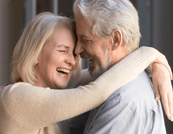 Two senior citizens smiling with new hair cuts from Hair Cuttery