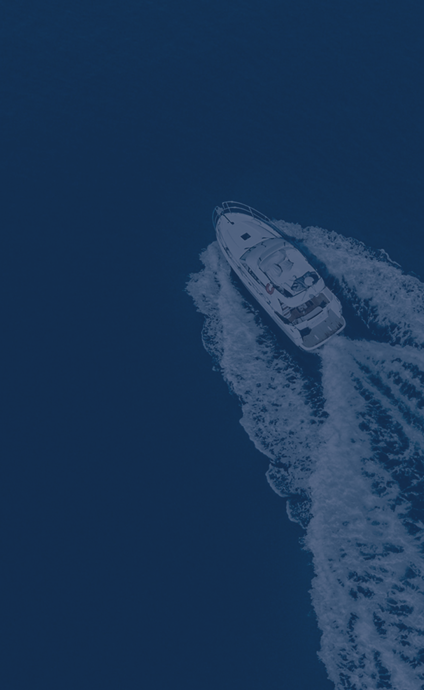 Aerial view of a motorboat cutting through deep blue water.