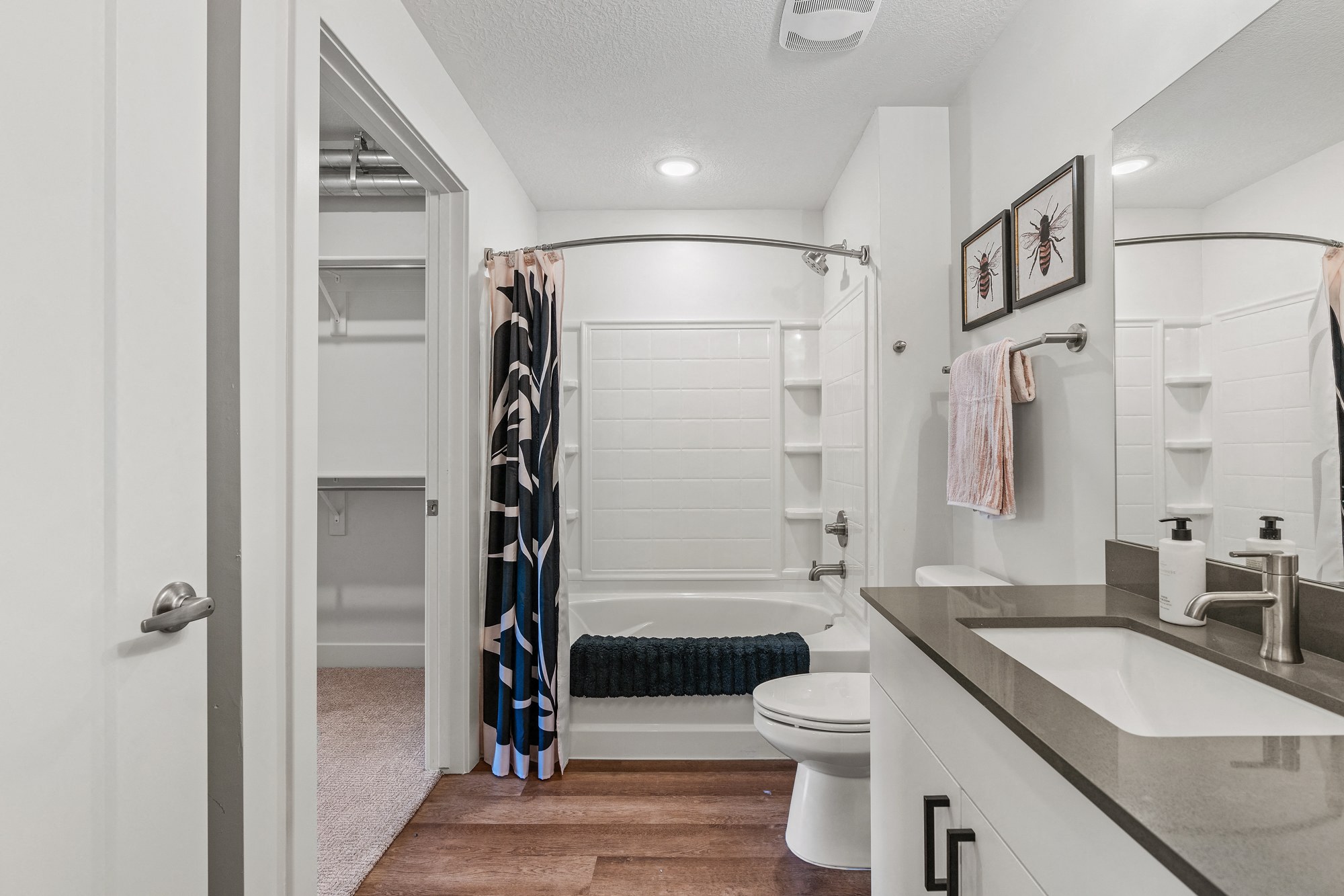 a bathroom with a shower and a toilet and a sink