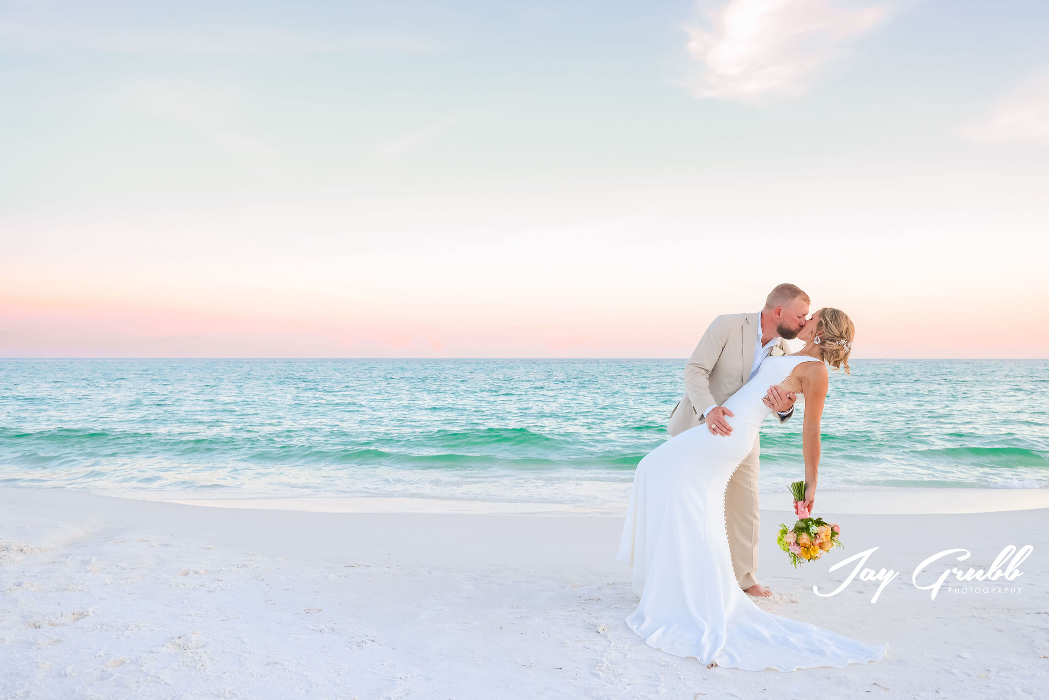 couple sharing passionate kiss on beach in Destin, Fl 