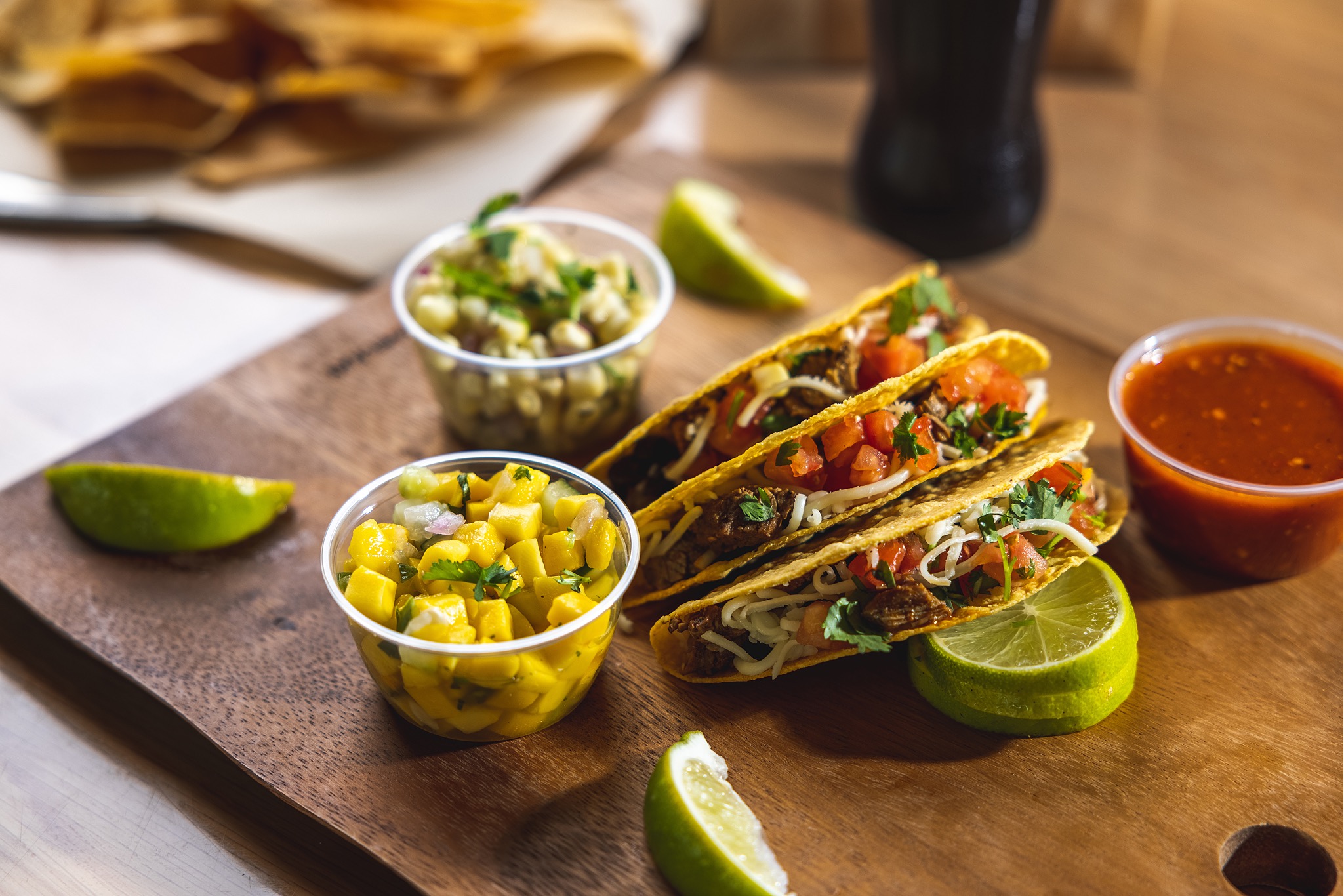 hard shell tacos fresh ingredients corn salsa and red salsa to dip 