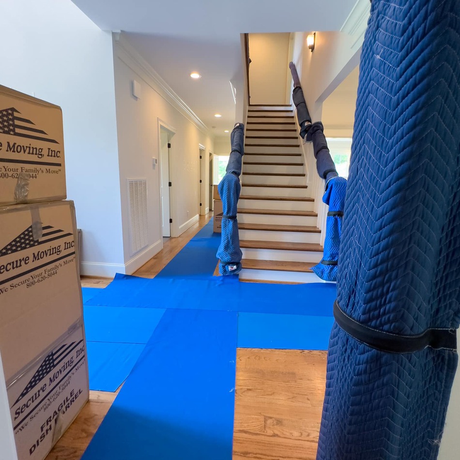 We pad and lay out the blue carpet to protect your items, belongings, floors, walls and home.
