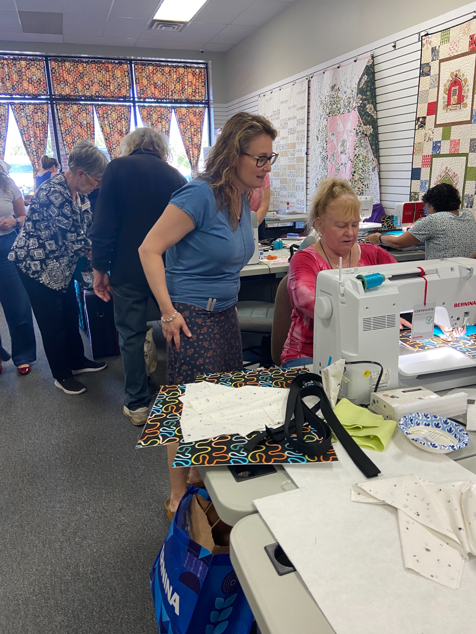 Students practice decorative stitch techniques during a hands-on quilting workshop, receiving personalized instruction while creating colorful projects and building confidence with their sewing machines.