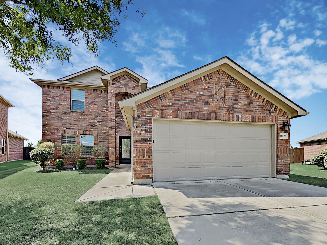 Beautiful brick home with a two-car garage at Invitation Homes Houston.