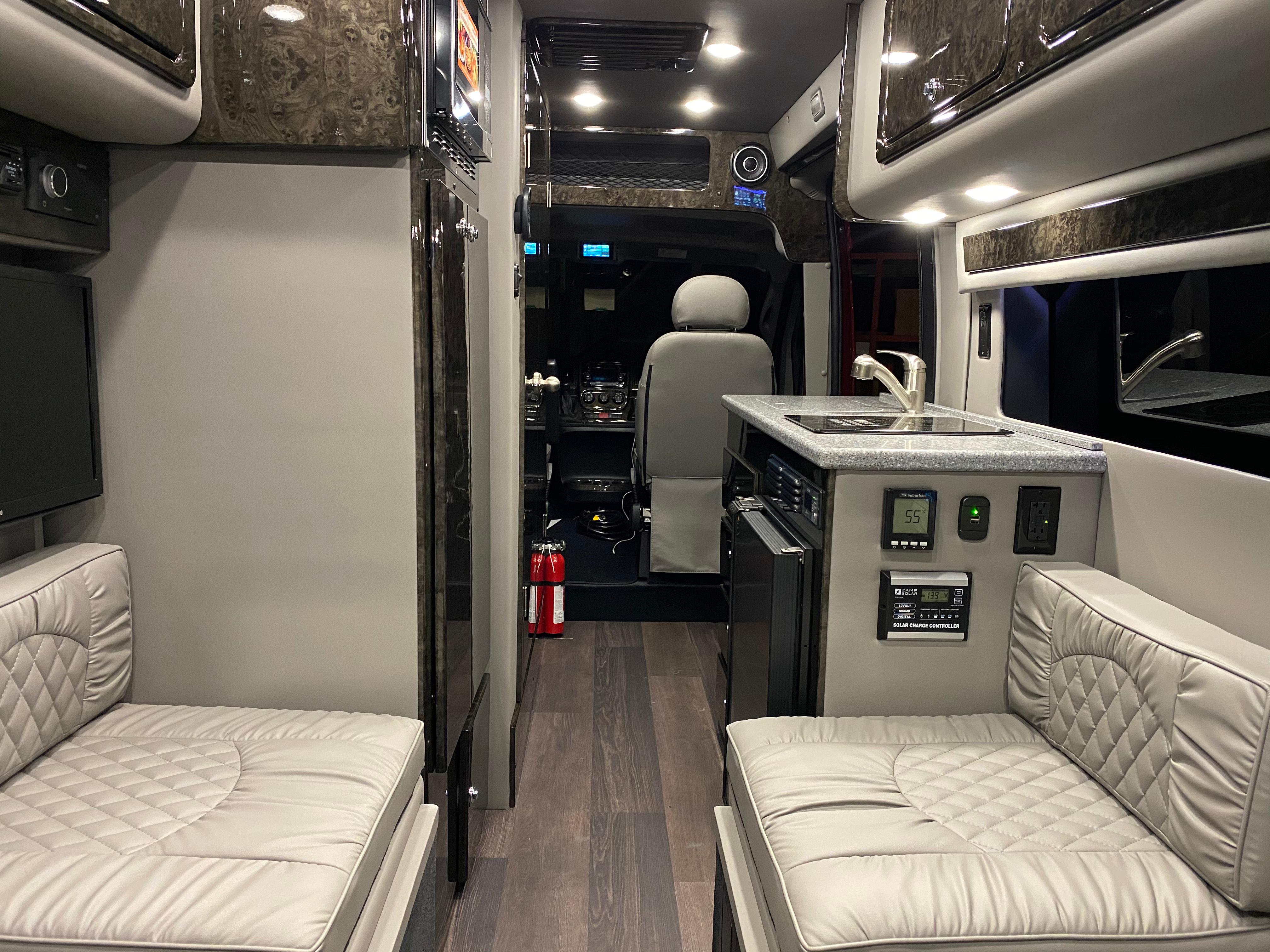 Mobile office on wheels. Conversion van with fridge, stove, sink, toilet, shower, and sleeping quarters.