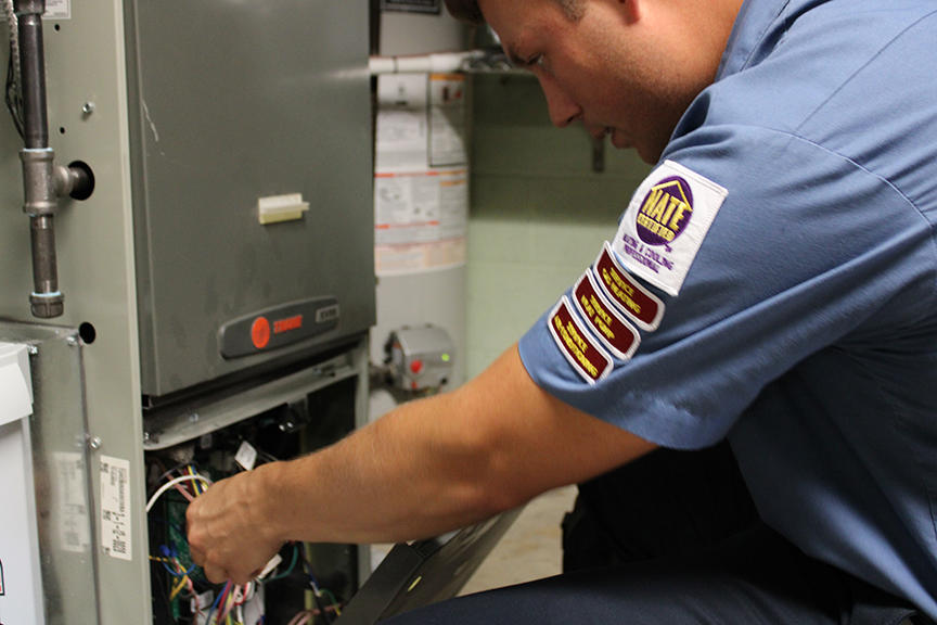 Service Tech performing a furnace inspection.