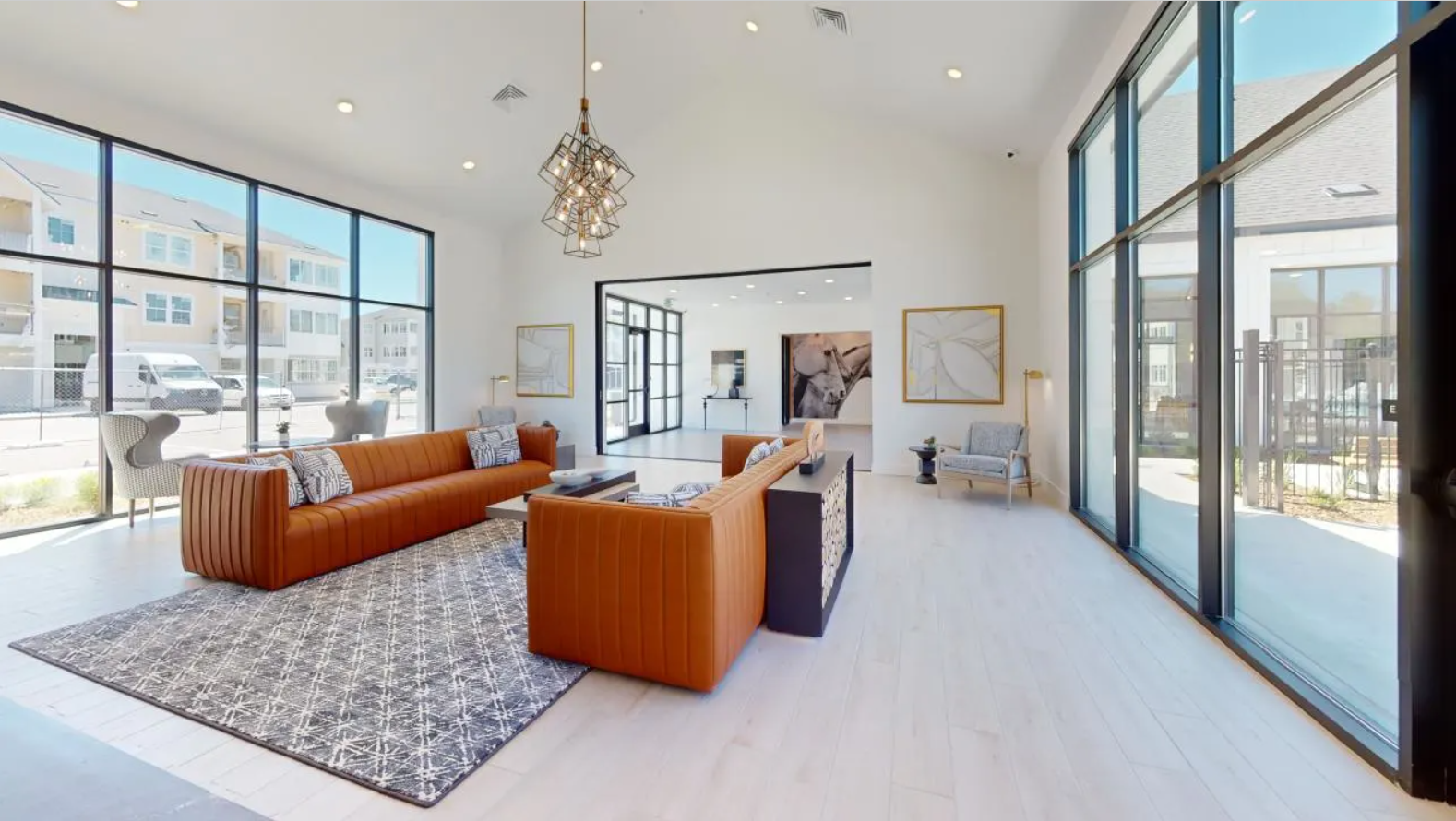 Resident lounge with orange furniture and large windows