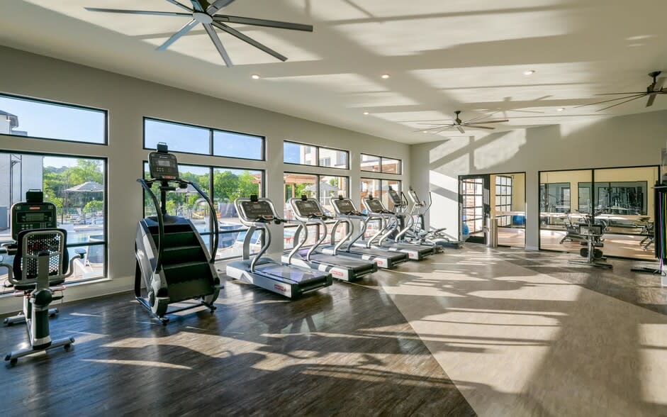 Gym with big windows and cardio equipment