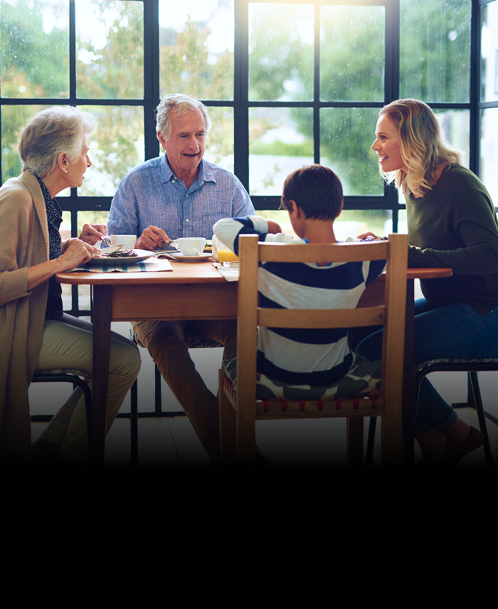 A multigenerational family enjoying a meal together at home.
