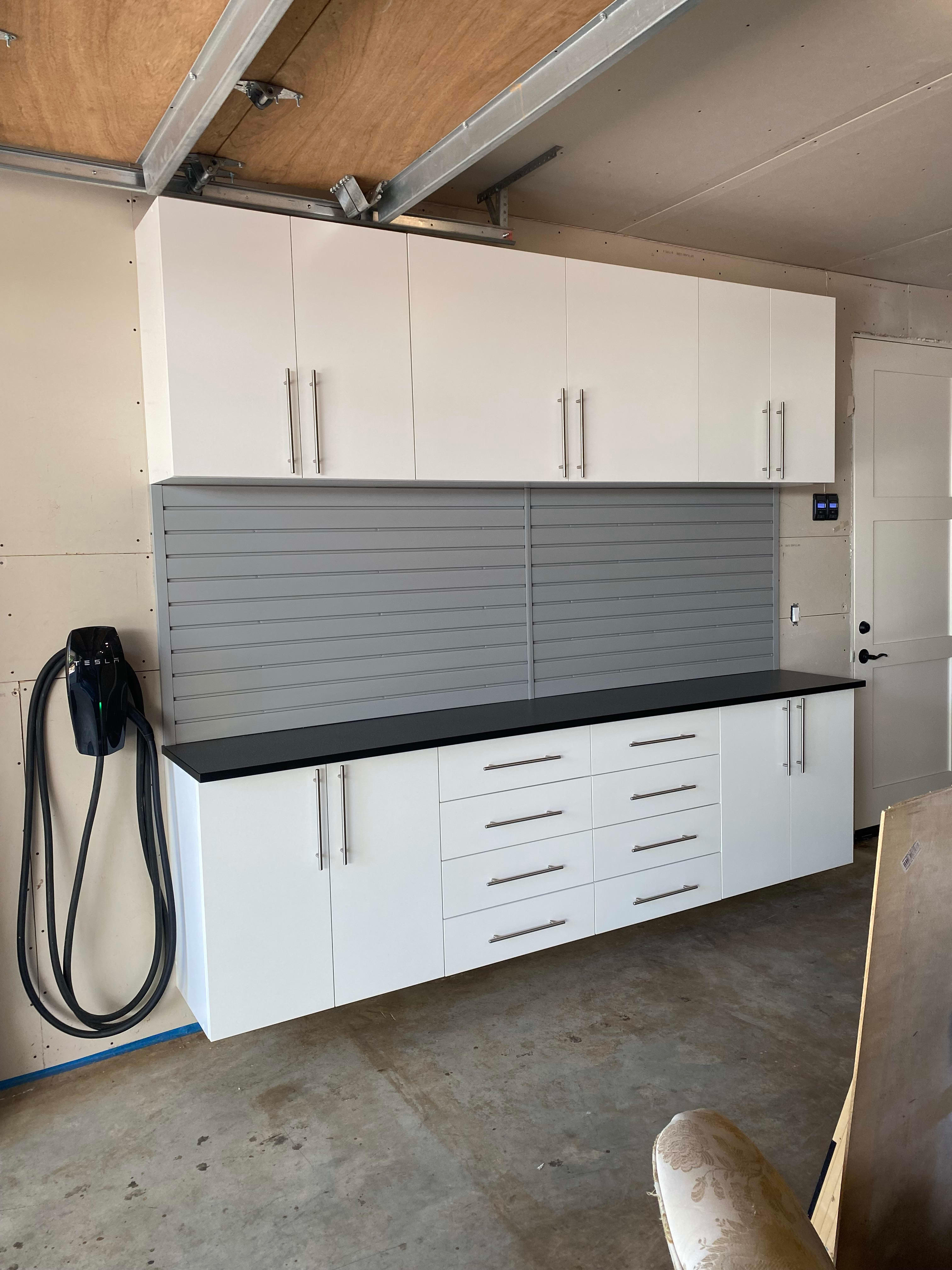 Custom Cabinet with countertop and slatwall by Premier Garage