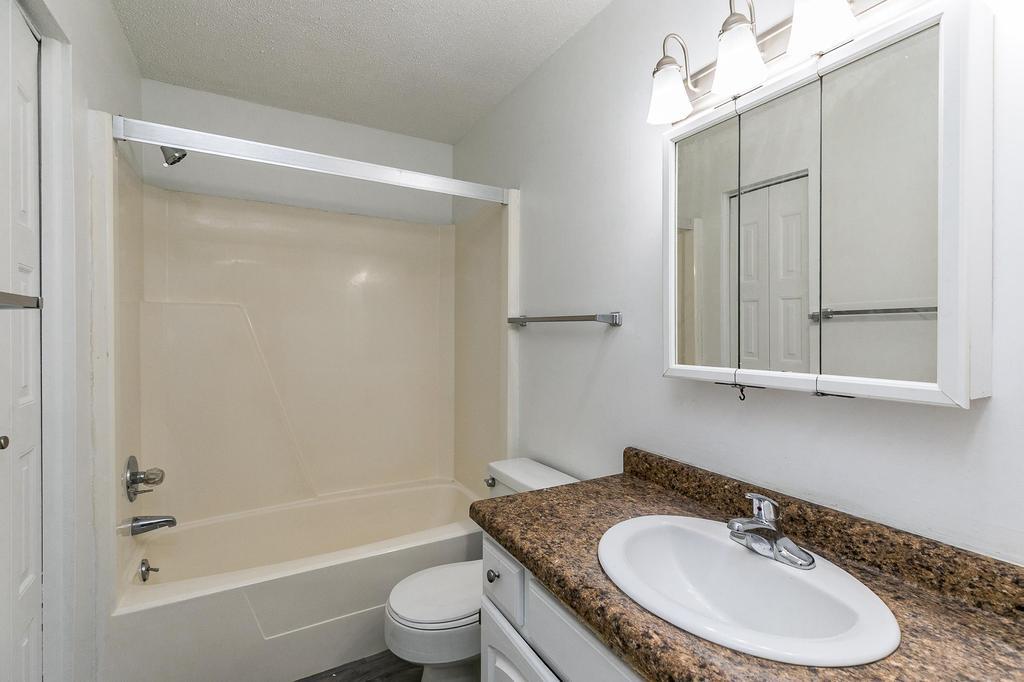 Bathroom With Tiled-Style Flooring