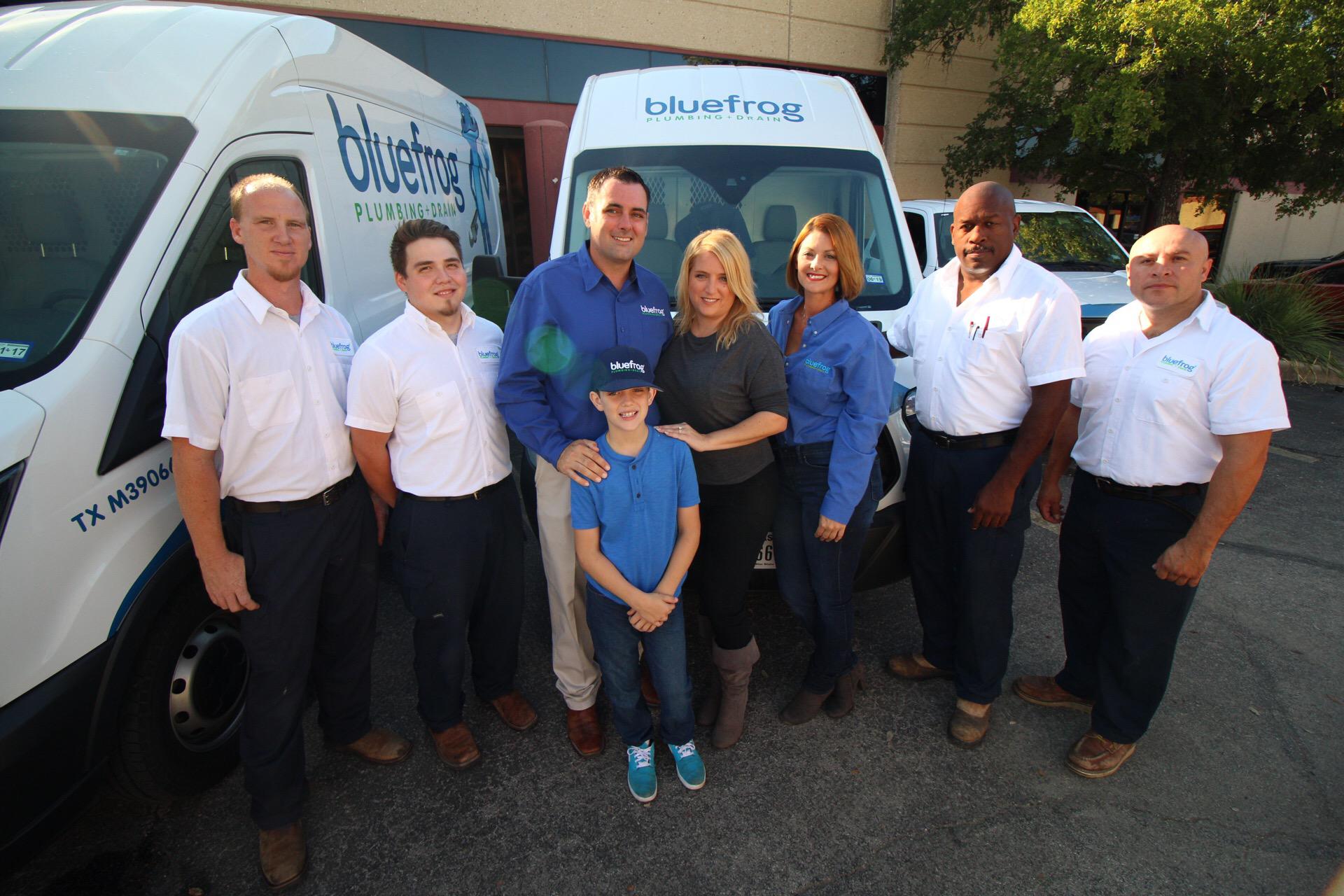 The bluefrog Plumbing + Drain of San Antonio team with their plumbing service trucks.
