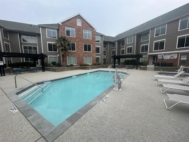 a swimming pool in the middle of an apartment building 