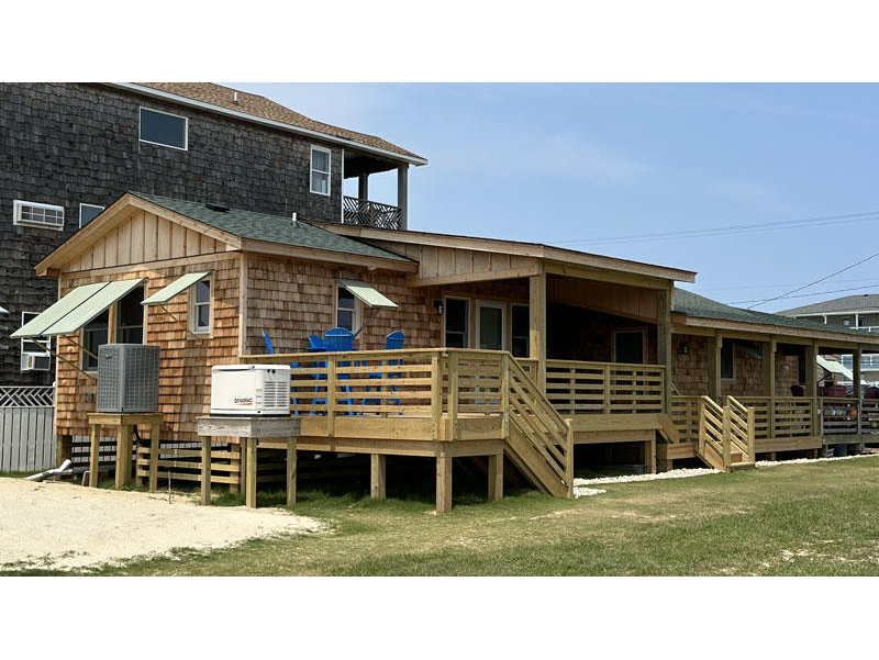 Custom home addition with Covered Porch, Natural Cedar Exterior, Handmade Juniper Shutters, and new Master Suite