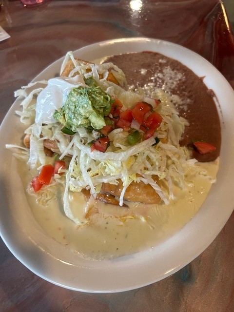 House Chimichanga served at Catramex Restaurant featuring a crispy stuffed tortilla filled with savory ingredients, authentic Mexican flavors, and fresh toppings in Southern Maine.