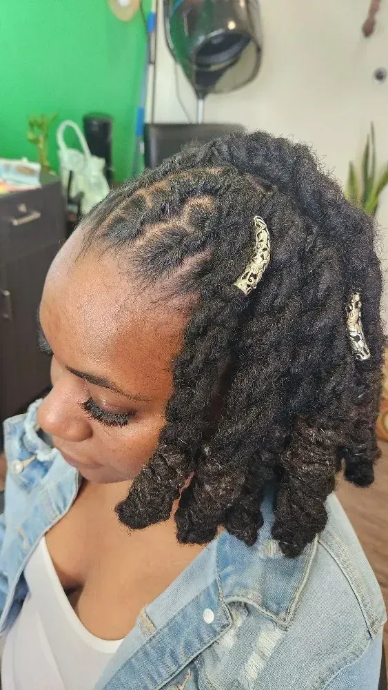 Shoulder-length loc bob featuring decorative hair accessories, soft texture, and neatly maintained r 