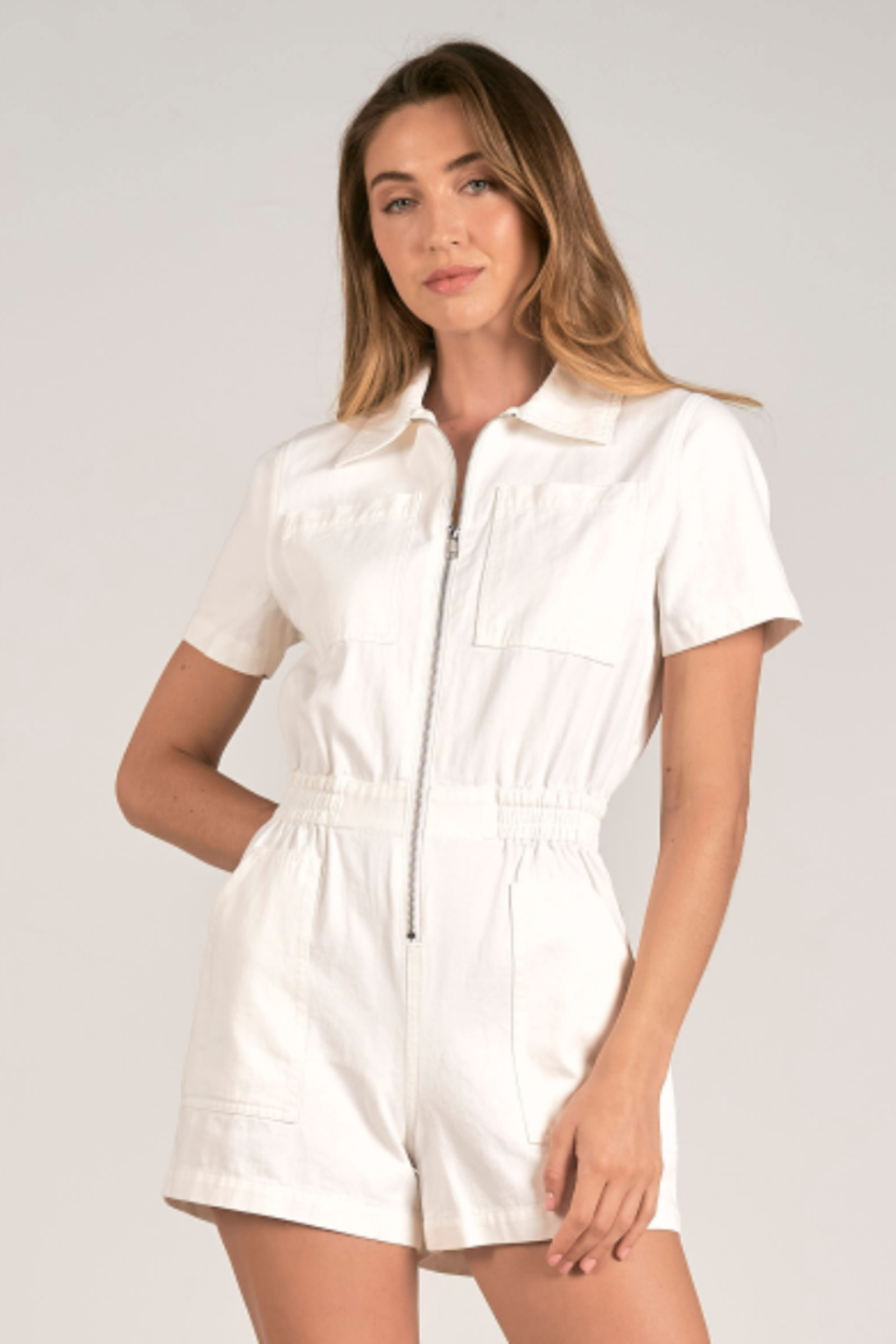 SHORT SLEEVE ZIP UP DENIM ROMPER WITH CHEST, SIDE AND BACK POCKETS AVAILABLE IN THE COLOR WHITE