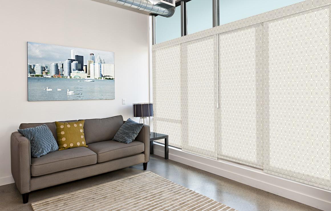 You’ve got to love a funky pattern, especially when it adds so much to a minimalist room!  Take some inspiration from the Sliding Panel Track Blinds we created for this space!  #BudgetBlindsGlendaleNorthHollywood  #PanelTrackBlinds #VerticalBlindAlternatives #FreeConsultation #WindowWednesday