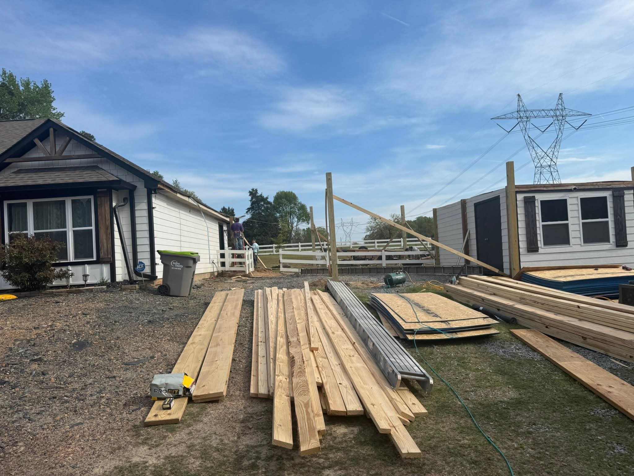 Stacks of lumber laid out with framing in progress