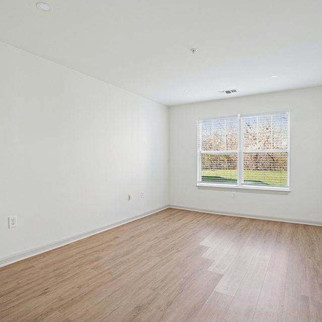 The Estates - Unfurnished Bedroom with Wood-Style Flooring