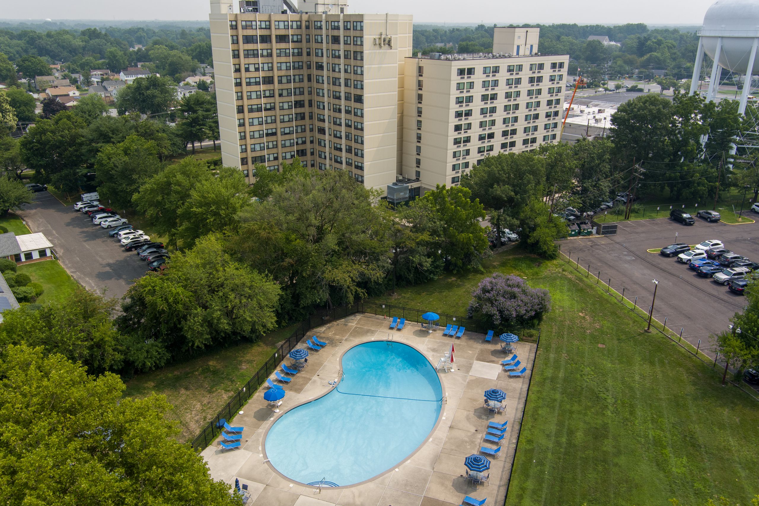 A large swimming pool surrounded by lawn chairs 