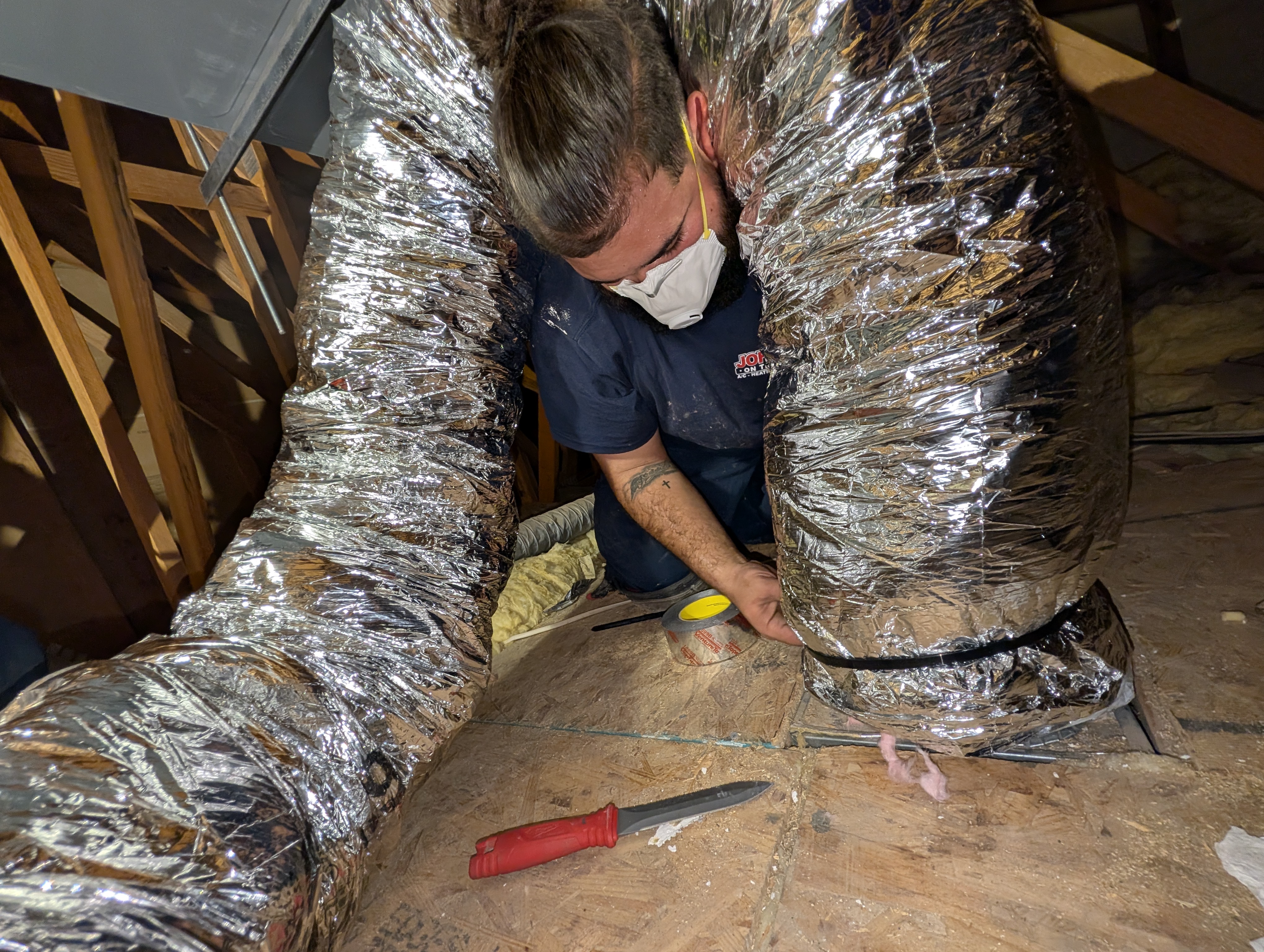 HVAC Tech installing new air ducts 